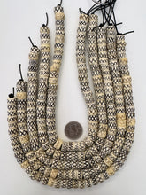 off white brown black, carved x motif, vintage stock bone, 12x7mm rondelle, 15" strand, SOLD PER STRAND