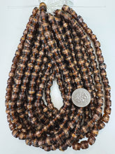 dark root beer brown metallic copper stripe swirl motif, vintage look glass, 9mm barrel, 15" strand, sold per strand