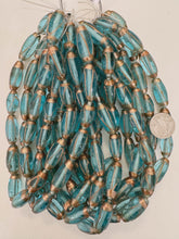 aqua blue metallic copper swirl, vintage look glass, 24-31mm bowed tube mix, 15" strand, sold per strand