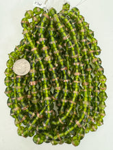 dark lime green amber metallic copper dotted stripe, vintage look glass, 12-15mm bowed tube, 15" strand, sold per strand