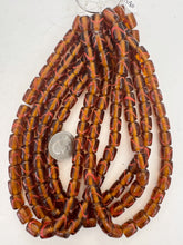 dark amber brown pale red swirl motif, vintage look glass, 12x9mm barrel, 15" strand, sold per strand