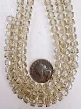 white flash coated pale dark topaz brown, fancy cut, vintage look glass, 7mm faceted bicone barrel, 9.5" strand, sold per strand