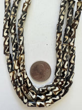 brown off white, coiled line motif, vintage stock bone, 8x6mm tube, 15" strand, SOLD PER STRAND