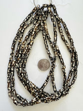brown off white, coiled line motif, vintage stock bone, 8x6mm tube, 15" strand, SOLD PER STRAND