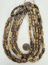 dark brown off white, dotted crossing lines motif, vintage stock bone, 18x7mm bowed tube, 15" strand, SOLD PER STRAND