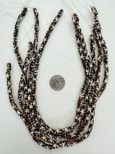 dark brown off white, starburst motif, vintage stock bone, 12x6mm rondelle, 15" strand, SOLD PER STRAND
