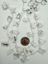 howiite, 18-20mm shape animal and nature motifs, 15" strand, sold per strand, may have some chipped or broken beads