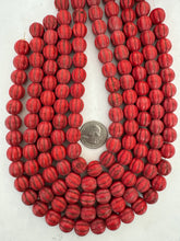 color enhanced magnesite: pale red, semi-dull finish, 12mm melon cut round, 15" strand,   SOLD PER STRAND