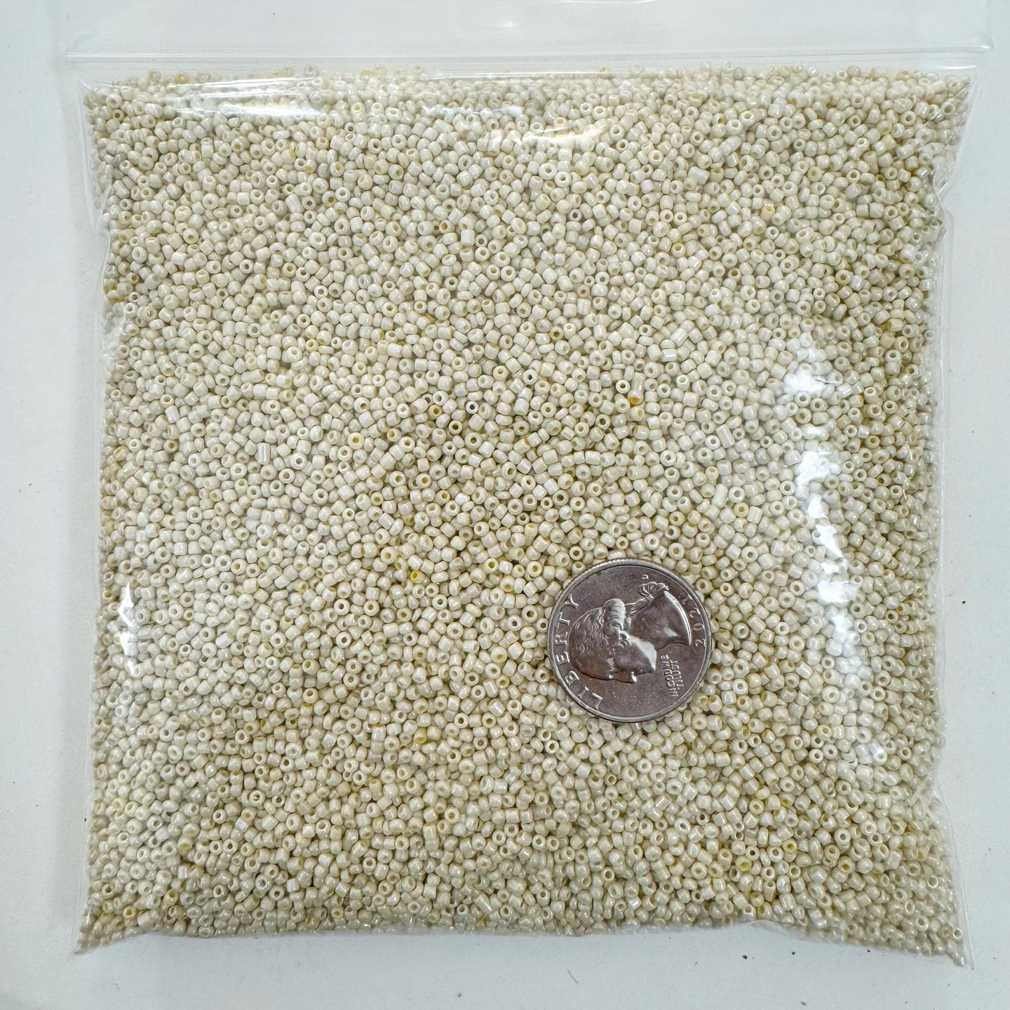 pearly orange off white, glass, 2mm rondelle seed beads, approximately 500 gram bag, sold per bag, made in India