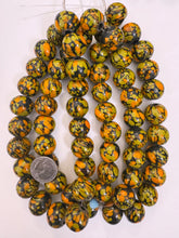 pale orange olive yellow black mix spotted swirl motif, vintage look glass, 20x18mm rondelle mix, 15" strand, sold per strand