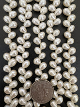 slightly off white, vintage stock fresh water pearl, 9x8mm diagonal top drilled potato size mix, 14.5" strand,  standard pearl size hole, SOLD PER STRAND