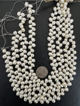 slightly off white, vintage stock fresh water pearl, 9x8mm diagonal top drilled potato size mix, 14.5" strand,  standard pearl size hole, SOLD PER STRAND