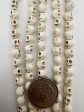 color enhanced magnesite: off white brown, 7mm skull, 15" strand,   SOLD PER STRAND