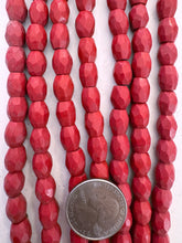 color enhanced magnesite: pale dark red, semi dull finish, 10x8mm faceted barrel, 15" strand, SOLD PER STRAND