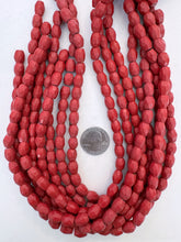 color enhanced magnesite: pale dark red, semi dull finish, 10x8mm faceted barrel, 15" strand, SOLD PER STRAND