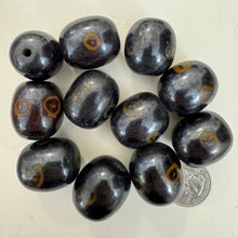 brown dark amber, evil eye motif, faux bone look, vintage stock resin, 26x23mm barrel, sold per bead