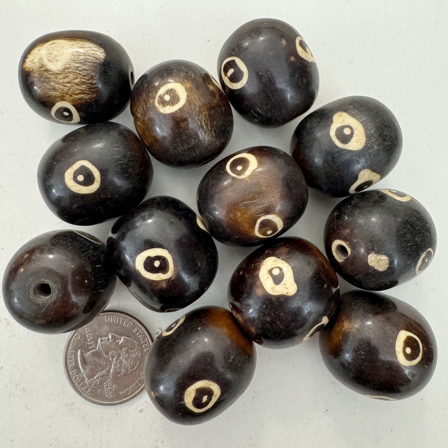 brown off white, evil eye motif, faux bone look, vintage stock resin, 26x23mm barrel, sold per bead