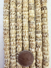 off white, carved dark designs mixed motif, vintage stock bone, 10x6mm rondelle, 15" strand, SOLD PER STRAND