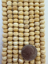 off white brown, carved lines motif, vintage stock bone, 9x7mm rondelle, 15" strand, SOLD PER STRAND