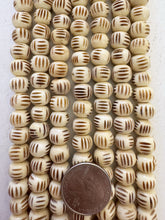off white black, carved parallel lines motif, vintage stock bone, 11x8mm rondelle, 15" strand, SOLD PER STRAND