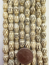 carved crossing lines motif, vintage stock bone, 12x9mm barrel,  16" strands,  SOLD PER STRAND