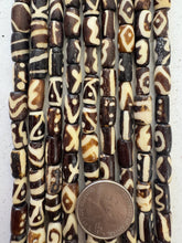 dark brown off white, mixed design motifs, vintage stock bone, 13x7mm tube, 15" strand, SOLD PER STRAND