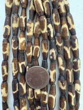 dark brown off white, swirl line motif, vintage stock bone, 23x7mm pointed tube filed bottom, 15" strand, SOLD PER STRAND