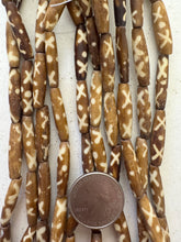 golden brown off white, x dot motif, vintage stock bone, 24x6mm bowed tube, 15" strand, SOLD PER STRAND