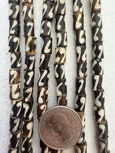 brown off white, coiled line motif, vintage stock bone, 8x6mm tube, 15" strand, SOLD PER STRAND