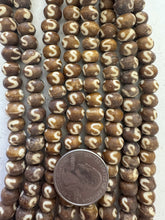 golden brown off white, s motif, vintage stock bone, 8x6mm rondelle, 15" strand, SOLD PER STRAND