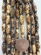 dark brown off white, dotted crossing lines motif, vintage stock bone, 18x7mm bowed tube, 15" strand, SOLD PER STRAND