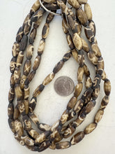brown off white, mixed spiral designs motif, vintage stock bone, 18x7mm bowed tube, 15" strand, SOLD PER STRAND