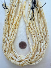 off white, carved open ovals motif, vintage stock bone, 25x7mm tube, 15" strand, SOLD PER STRAND