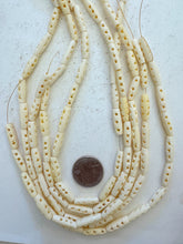 off white, carved open circles x motif, vintage stock bone, 18x5mm tube, 15" strand, SOLD PER STRAND