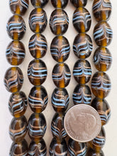 brown pale blue copper, drawn swirl motif, vintage stock glass, 20x14mm barrel,   6" strand, SOLD PER STRAND