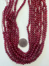 color enhanced quartz: ruby red, 6mm faceted round, 15" strand,  SOLD PER STRAND