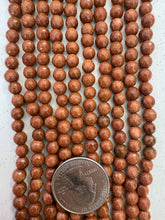 goldstone, 6mm faceted round, 15" strand,   SOLD PER STRAND
