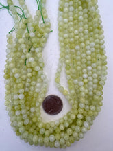 color enhanced quartz: bright pale lime green, 6mm round, 15" strand, SOLD PER STRAND