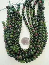 color enhanced quartz: dark olive green ruby red, 8mm faceted round, 15" strand,   SOLD PER STRAND