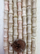 color enhanced quartz: off white very pale pink, 16x8mm dent tube, 15" strand,  SOLD PER STRAND