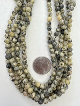 color enhanced serpentine: pale yellow, 6mm faceted round, 15" strand,  SOLD PER STRAND