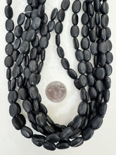 matte black stone, dull finish surface wear, 13x10x5mm oval, 15" strand, SOLD PER STRAND