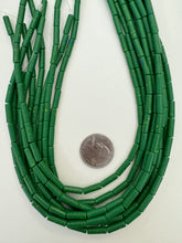 color enhanced magnesite: pale dark blue green yellow spots, 14x4mm tube, 15" strand,  SOLD PER STRAND