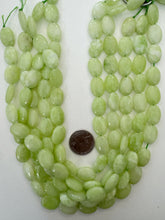 color enhanced quartz: bright light lime green, 17x14x6mm oval, 15" strand,  SOLD PER STRAND