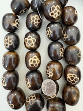 dark brown off white flower motif, faux bone, vintage look resin, 33x29mm barrel, 15" strand,    SOLD PER STRAND