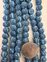pale blue black, matte finish, carved buddha skull motif, vintage stock resin, 10mm round, 15" strand,  SOLD PER STRAND