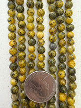 color enhanced serpentine: yellow, 6mm round, 15" strand,   SOLD PER STRAND