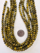 color enhanced serpentine: yellow, 6mm round, 15" strand,   SOLD PER STRAND