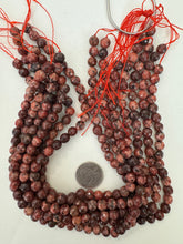 color enhanced serpentine: dark pale red orange, 8mm faceted round, 15" strand, sold per strand