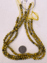 color enhanced serpentine: yellow, 6mm faceted round, 15" strand, sold per strand